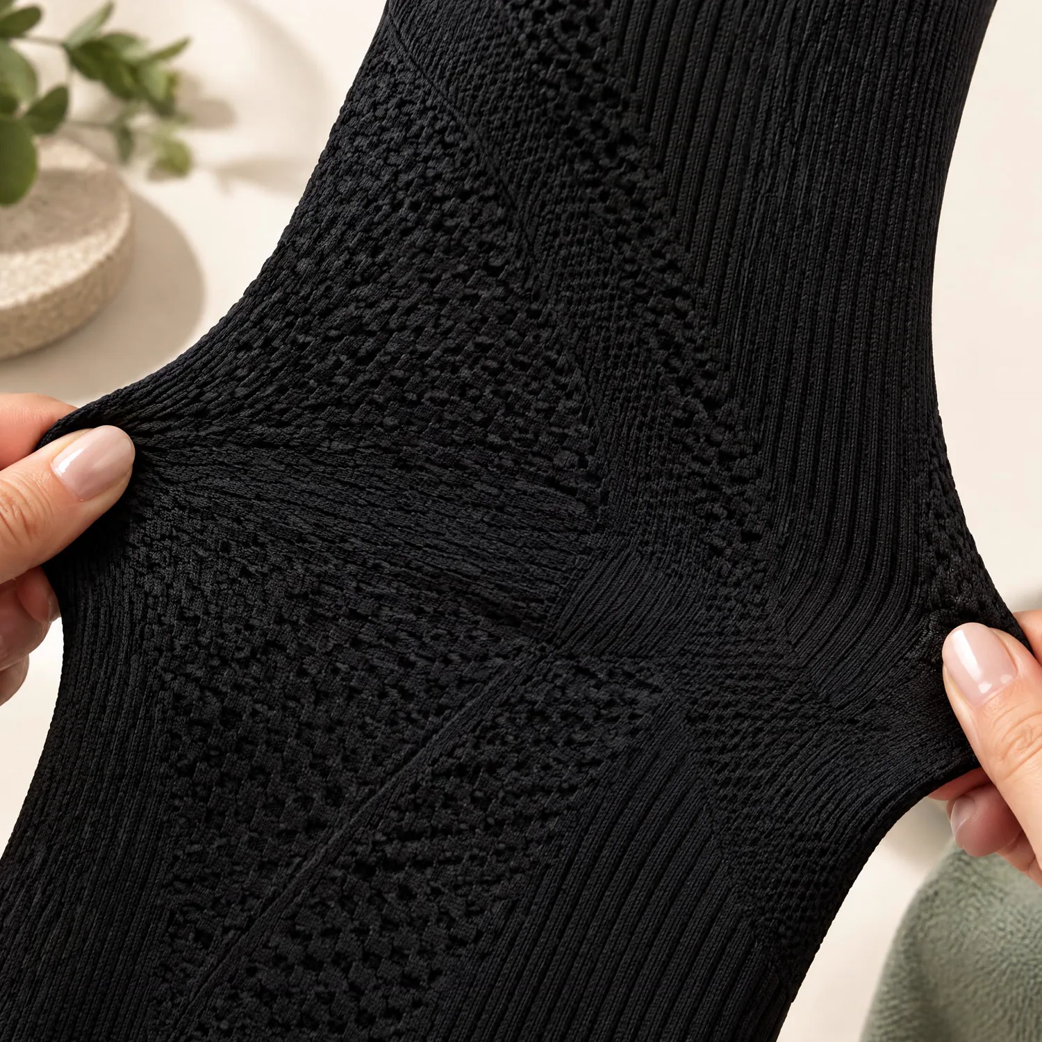 Close-up of the 3D textured knit fabric being gently stretched